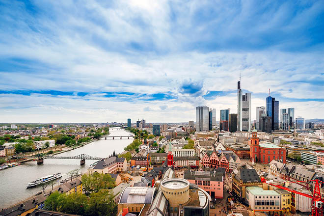 Panoramic view on Frankfurt skyline and Romerberg City Hall Square in Frankfurt in Germany. The Romerberg consists of old houses. Tourists nearby
