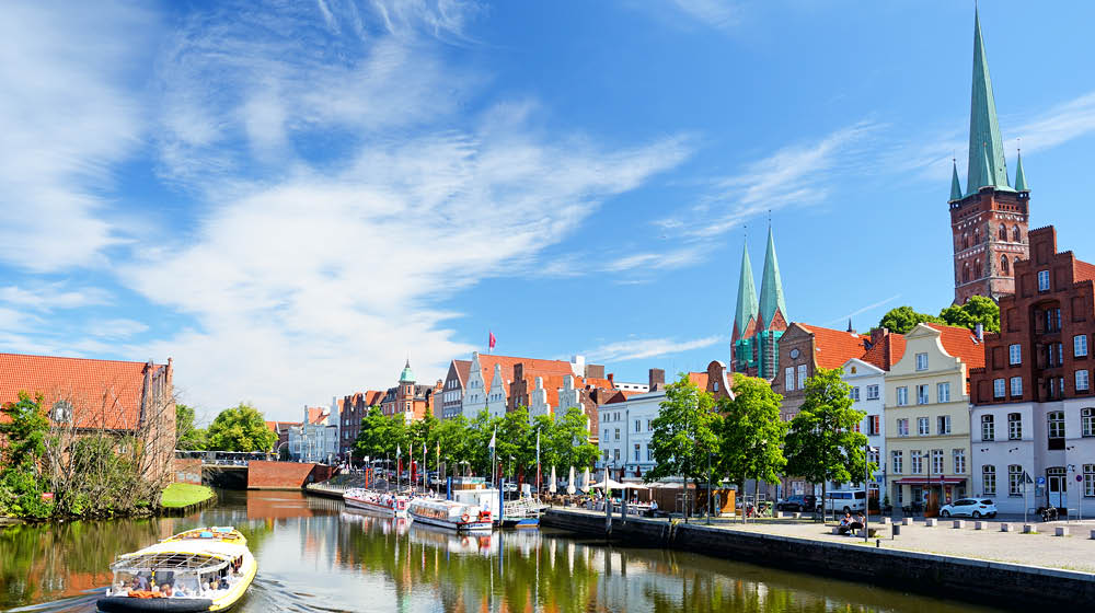 L beck old town and River Trave at sunny day, Germany. Composite photo