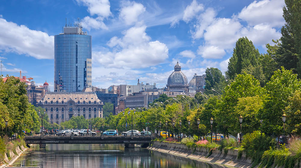 Late spring in Bucharest. View towards the Dambovita river, in the background among other buildings, the tall financial plaza building and the roof of the CEC palace.