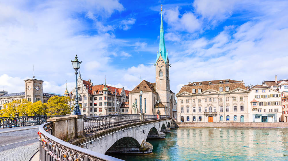 Zurich, Switzerland. View of the historic city center with famous Fraumunster Church, on the Limmat river.
