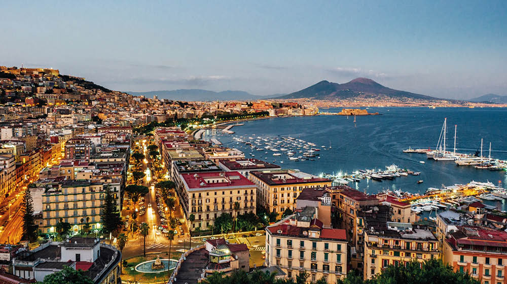 Naples at sunset - Gulf of Naples, Italy. View of the city from elevated point of view.