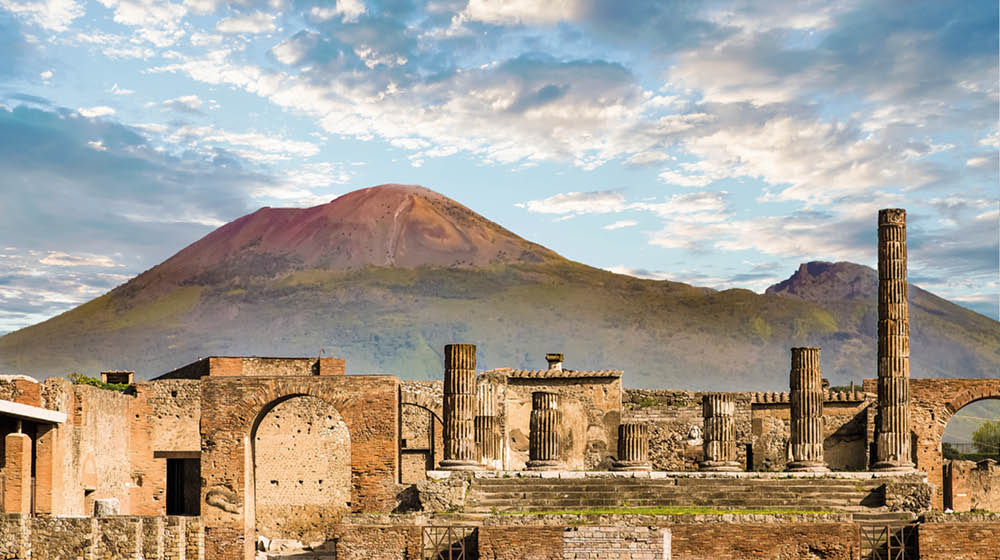 Ancient walls in Pompeii with volcano Vesuvius in the background
