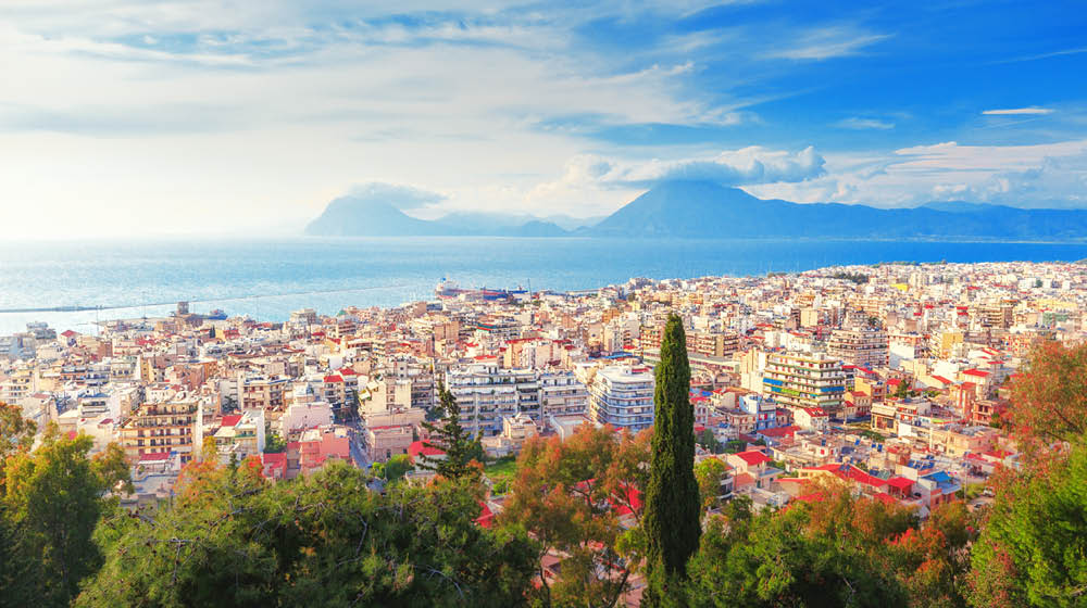 Patras city, Greece, view from above scenery. Patras is Greece's third-largest city and the regional capital of Western Greece, in the northern Peloponnese, 215 km (134 mi) west of Athens.