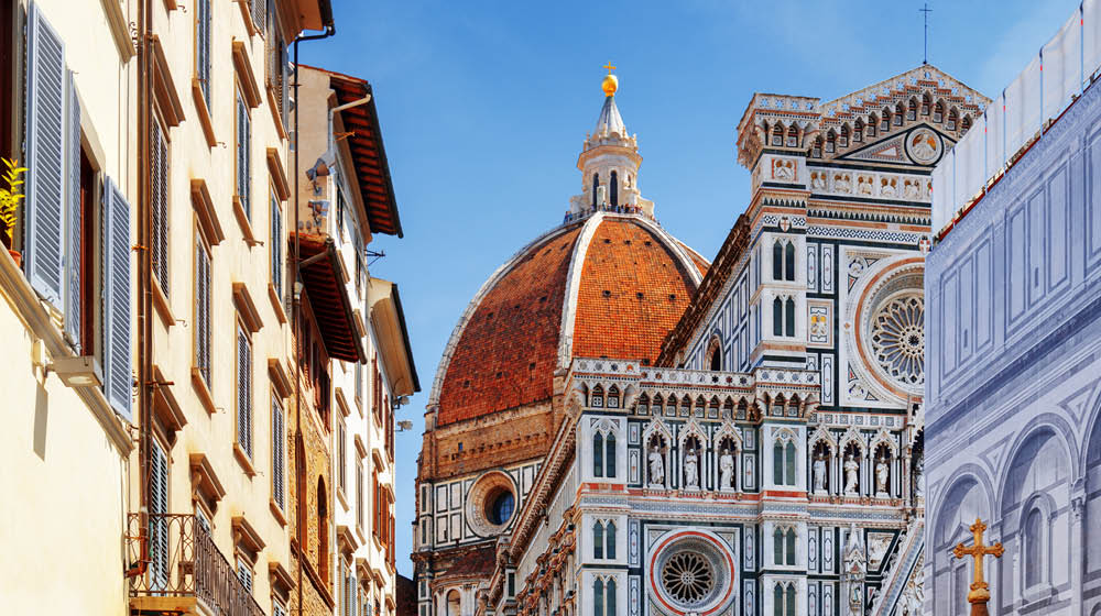 The Cathedral of Saint Mary of the Flower (Florence Cathedral) at historic center of Florence, Tuscany, Italy. View from the Piazza San Giovanni. Dome on blue sky background.