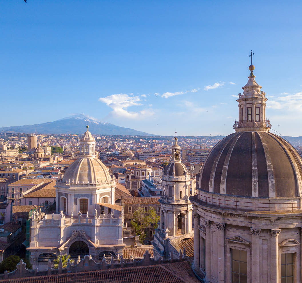 Beautiful aerial view of the Catania city near the main Cathedral and Etna volcano on the background. Amazing old town view from above.