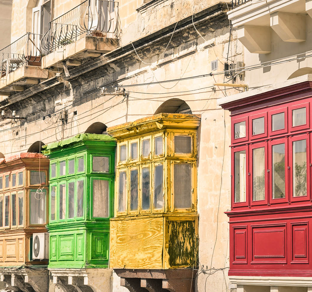 Vintage view of typical buildings balconies in La Valletta - Colorful travel in Malta on the road - Popped up filtered version