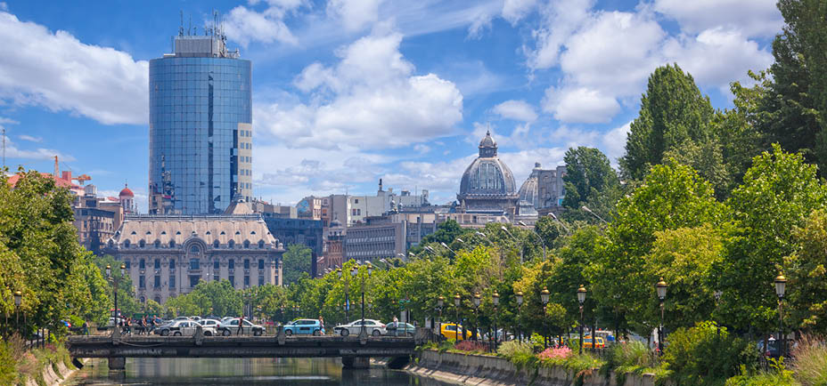 Late spring in Bucharest. View towards the Dambovita river, in the background among other buildings, the tall financial plaza building and the roof of the CEC palace.