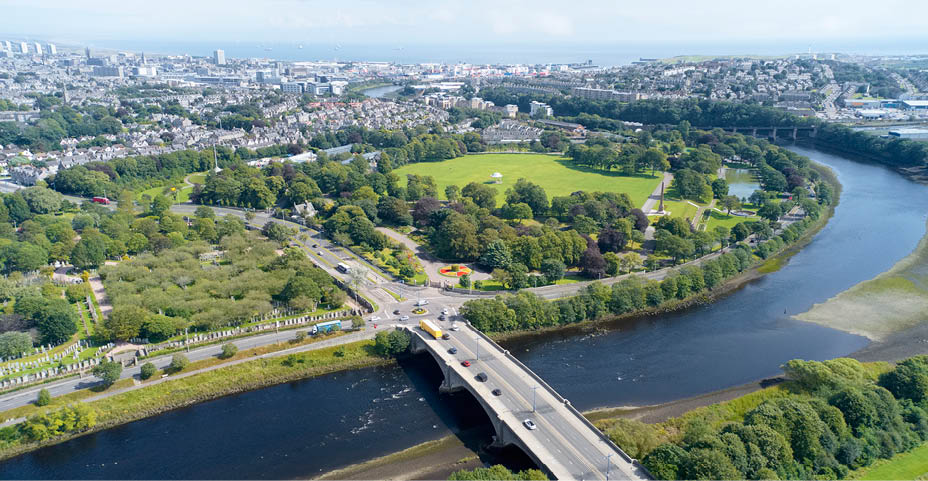Aerial view of Aberdeen as River Dee flows in a curve to the North Sea showing Duthie Park with bridge and traffic from south uk