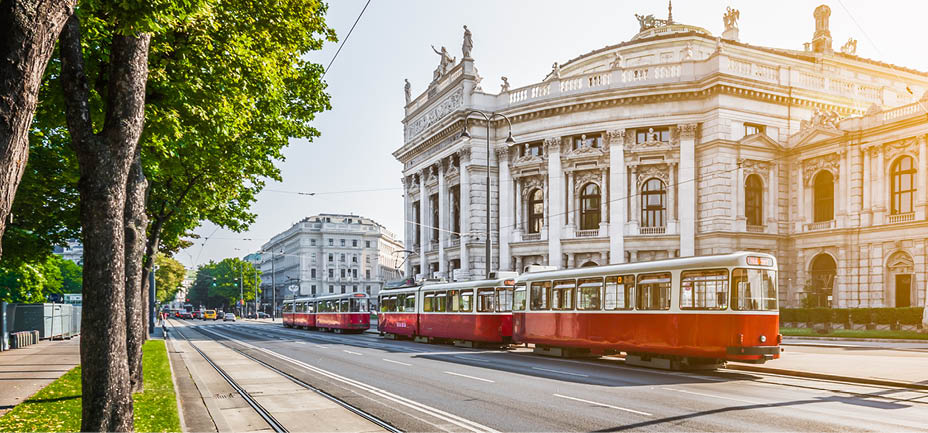 Famous Wiener Ringstrasse with historic Burgtheater (Imperial Court Theatre) and traditional red electric tram at sunrise with retro vintage Instagram style filter effect in Vienna, Austria.