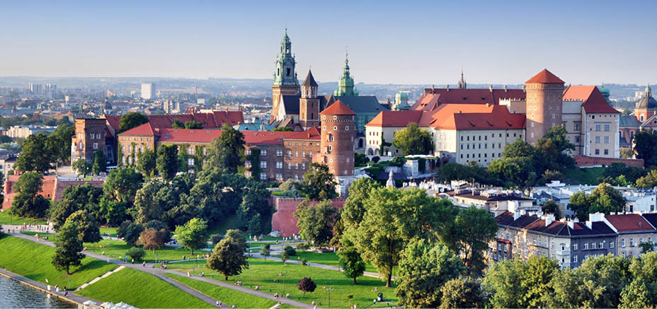 Historic royal Wawel castle in Cracow, Poland with park and Vistula river. Aerial view at sunset.