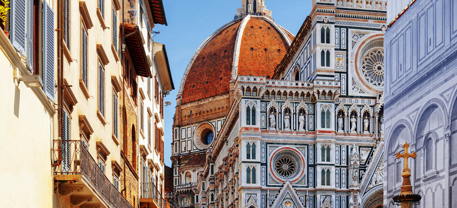 The Cathedral of Saint Mary of the Flower (Florence Cathedral) at historic center of Florence, Tuscany, Italy. View from the Piazza San Giovanni. Dome on blue sky background.