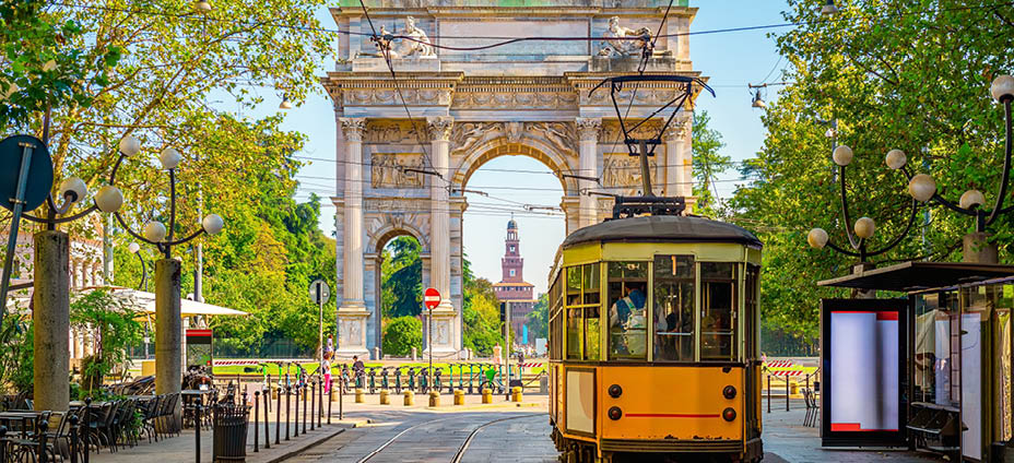 View of the Peace Arch with yellow tram in Milan, Italy